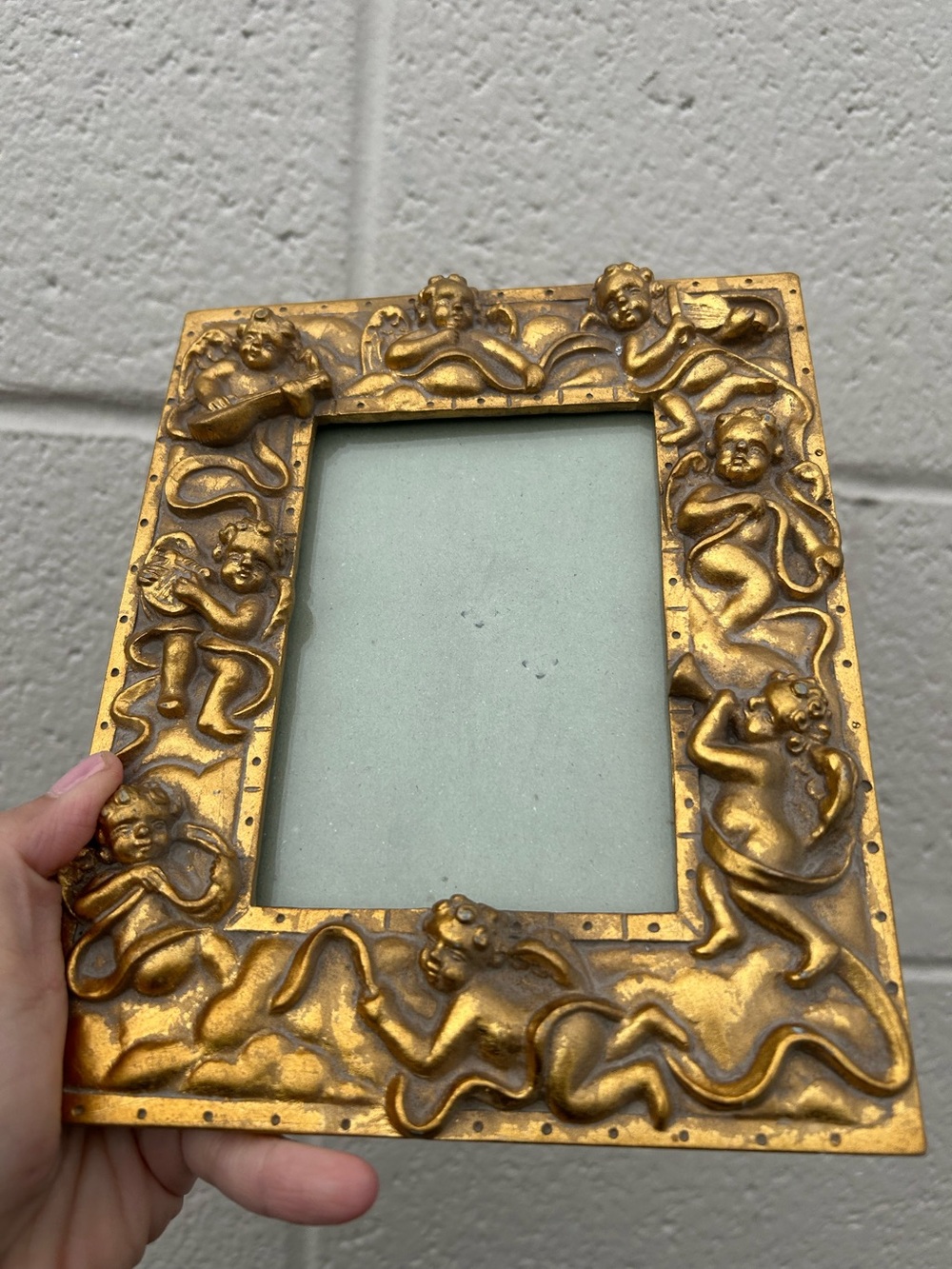 vintage-style gold ornate picture art frame decorated with raised relief figures